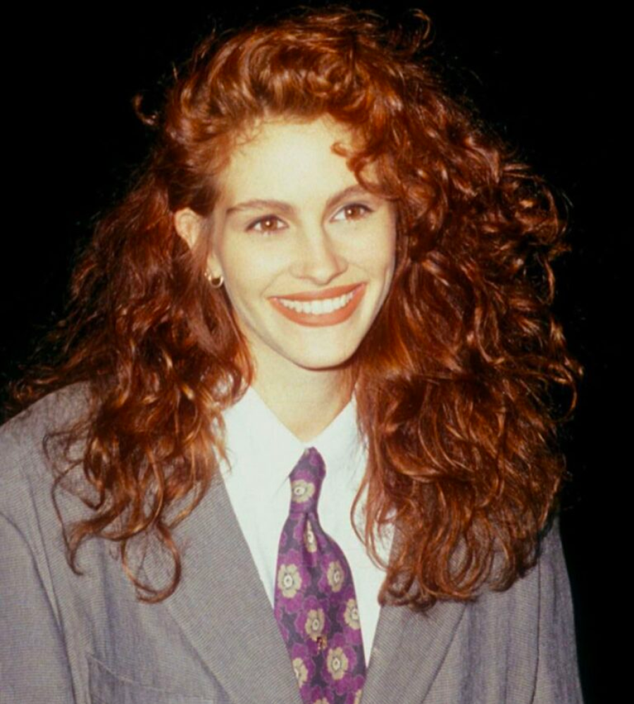 Vintage photo of Julia Roberts in a grey suit with long auburn curls